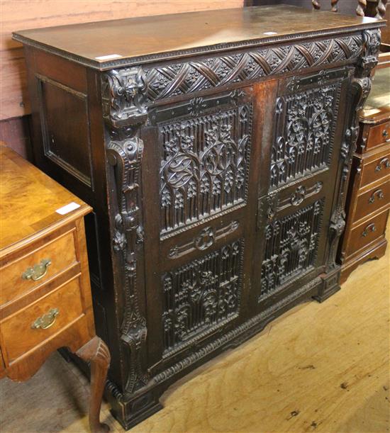 Oak two-door cabinet, with earlier carved door panels